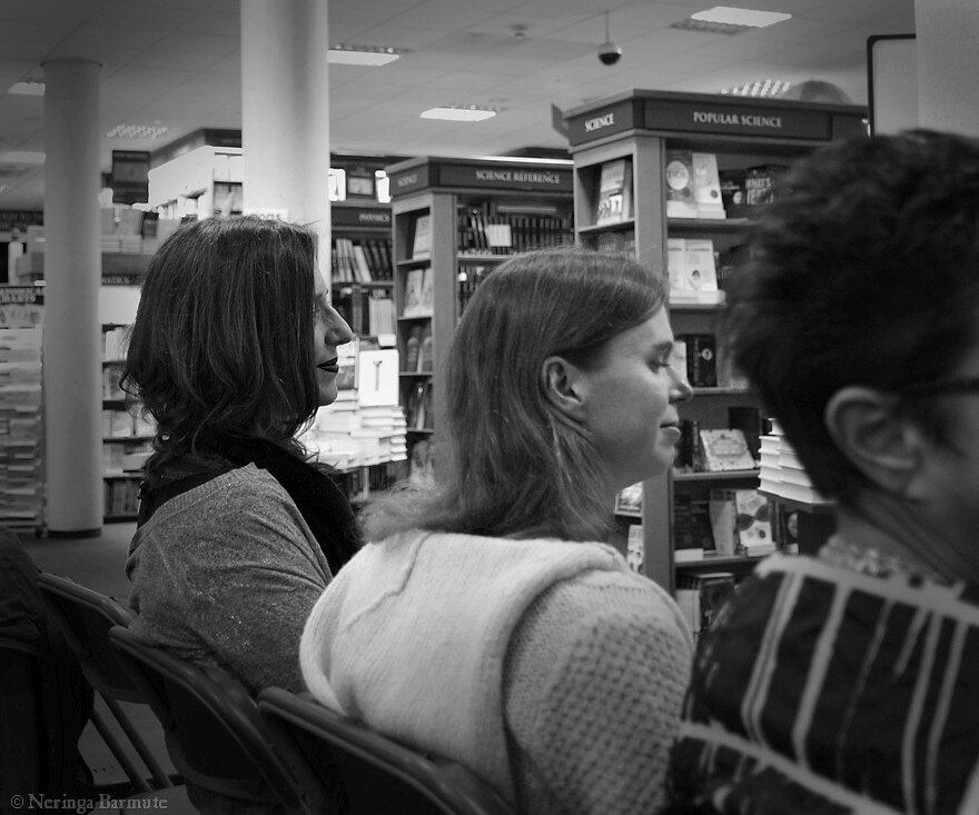 Elise Valmorbida sitting among the audience while listening to her story being read out aloud